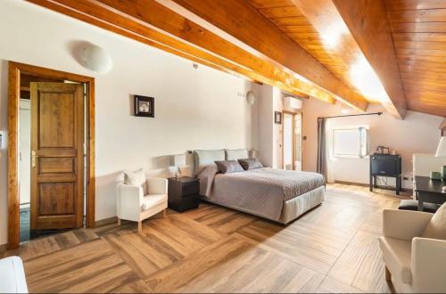 ein Schlafzimmer mit einem Bett und einem Stuhl in einem Zimmer in der Unterkunft Palazzo Candida B&B in Gerace