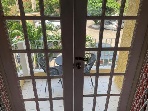 an open door with a view of a patio at Finest Accommodation Apt # 424 Marley Manor Block 4 6 Marley Rd Kgn 6 in Kingston