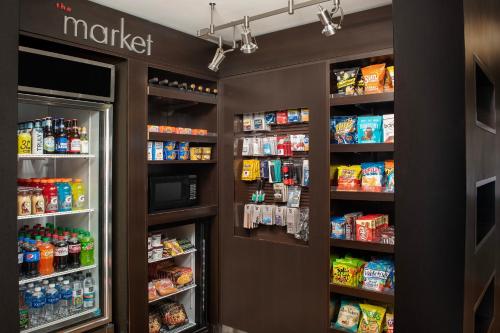 a grocery store aisle with two refrigerators and food at Courtyard by Marriott Dayton Beavercreek in Beavercreek