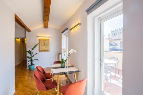 a room with a table and chairs and a window at Condotta 16 Apartments in Florence