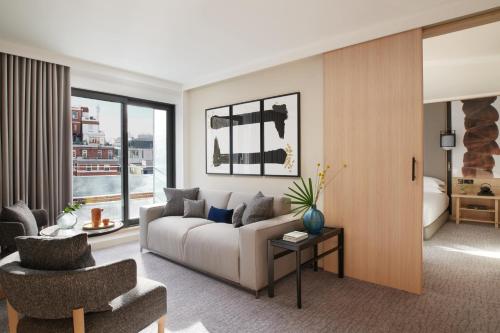 a living room with a couch and a chair at Nobu Hotel London Portman Square in London
