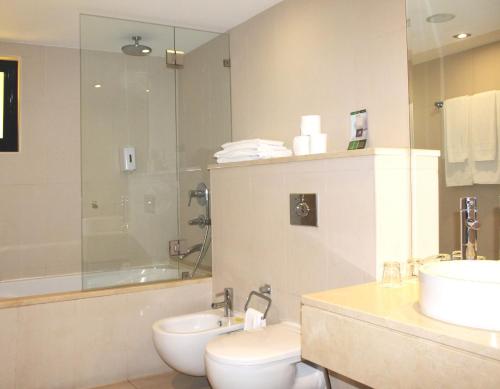 a bathroom with a toilet and a sink and a shower at AP Adriana Beach Resort in Albufeira