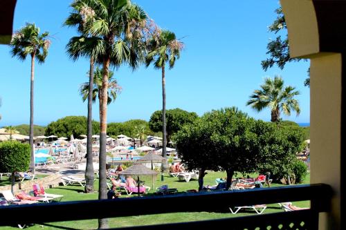 a view of a resort with palm trees and a pool at AP Adriana Beach Resort in Albufeira