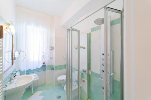 a bathroom with a shower and a toilet and a sink at Hotel San Pietro in Maiori
