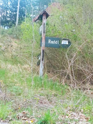a street sign on a pole in a field at Verina kuća in Kosjerić