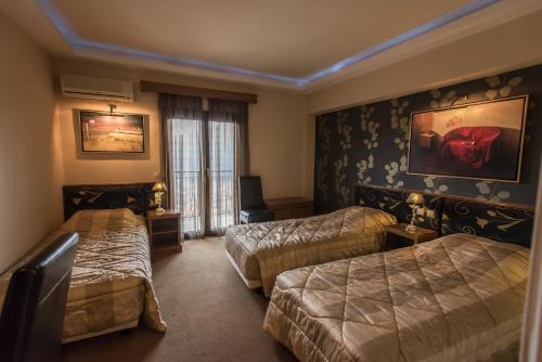 Ένα ή περισσότερα κρεβάτια σε δωμάτιο στο Anesis Hotel