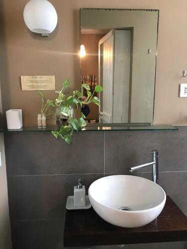 a bathroom with a white sink and a mirror at La Combriccola in Santarcangelo di Romagna