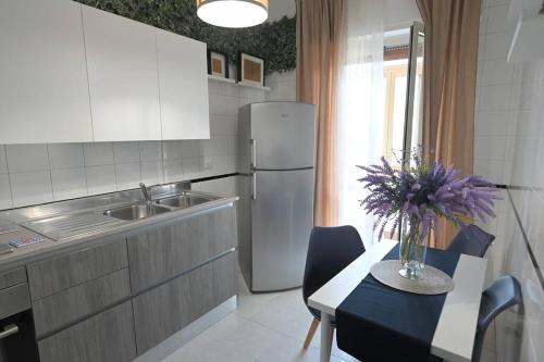 a kitchen with a table and a refrigerator at Vista Mare casa vacanze in Torre Annunziata