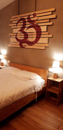 a bedroom with a bed with a sign on the wall at B&B EcoAntico casa in paglia in Maiolo