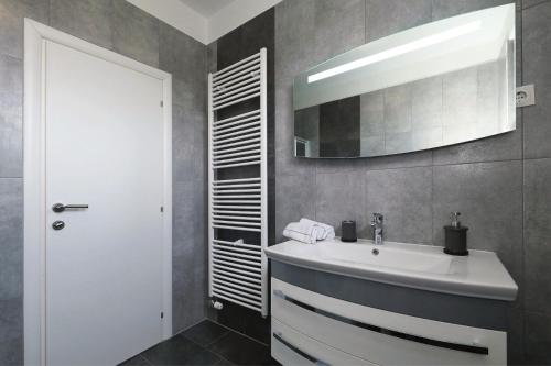 a bathroom with a sink and a mirror at Ferienhaus Dalmatia bei Zadar in Zadar