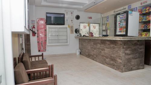 a store with a counter and a snowboard on the wall at Hotel La Ínsula in Cúcuta