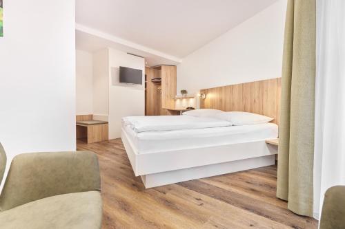 Кровать или кровати в номере Hotel Garni Gästehaus am Mühlbach