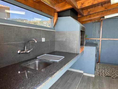 a kitchen with a sink and a window at Casa Bela Vista in Venda do Atalhinho