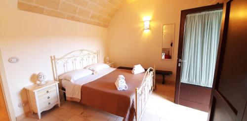 a bedroom with a bed and a dresser and a window at Lamia Pieranna in Cisternino