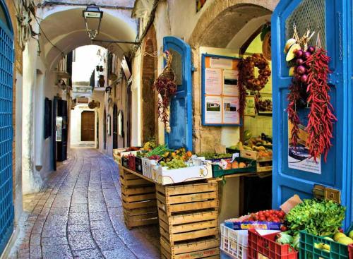 a market with fruits and vegetables on display in an alley at Divina Casa Vacanze Donna Silvana in Sperlonga