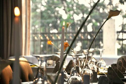 a table with many wine glasses and flowers on it at The Swiss Hotel Freetown in Freetown