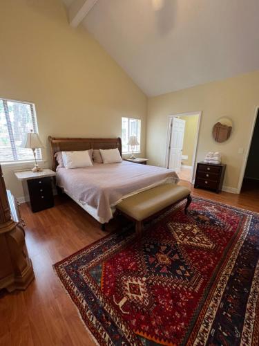 a bedroom with a large bed and a rug at Resort Like house, 4 bedrooms, 3 bathrooms in Orlando