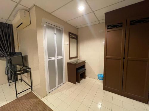 a small bathroom with a sink and a mirror at Barrack Street Hotel in Taiping