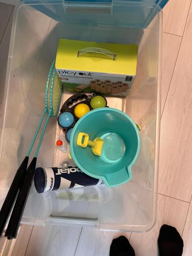 a plastic container with paint brushes and a box at Appart - Rés du Parc- Hardelot in Hardelot-Plage