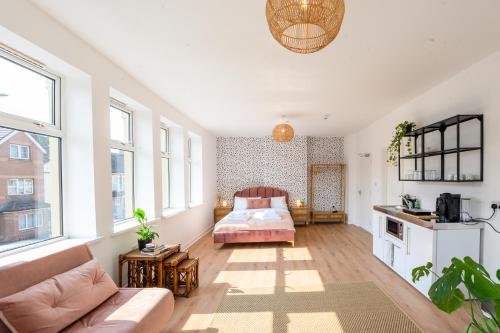 a living room with a bed and a couch at Neighbourhood Bedrooms in Cardiff