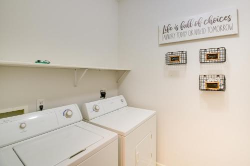 a laundry room with white appliances and a sign on the wall at Hot Springs Vacation Rental with Pool Access and Deck! in Hot Springs