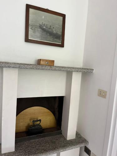 a living room with a fireplace with a wooden at Casa Dilma in Lenno