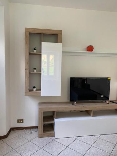 a flat screen tv sitting on top of a entertainment center at Casa Dilma in Lenno