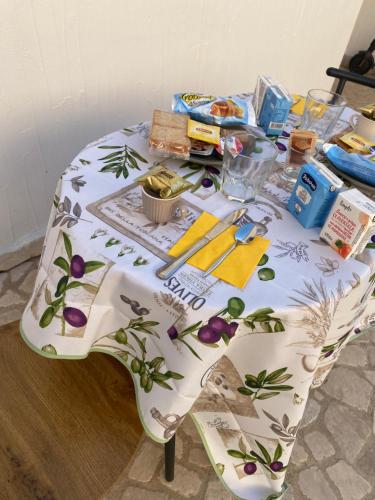 a table with a table cloth on it with food on it at Guest House Sciola - TS ROOMS B&B in San Sperate