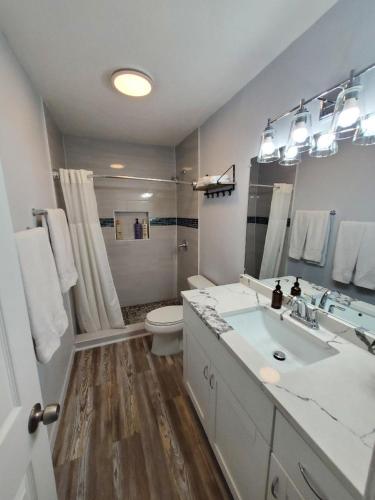 a white bathroom with a sink and a toilet at Condo Near Downtown Austin - 2br in Austin