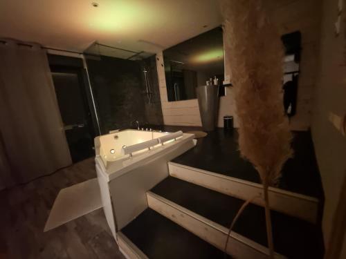 a bathroom with a white tub and a sink at Love Loft in Bordeaux
