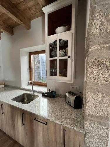 a kitchen with a sink and a counter top at Refugio del nogal - Cercedilla in Cercedilla