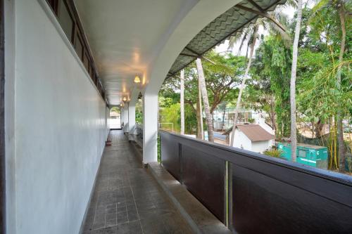 a hallway of a house with a view of trees at Blu Missel By The River in Panaji