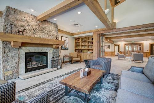 a large living room with a stone fireplace at Mountain Thunder Lodge in Breckenridge