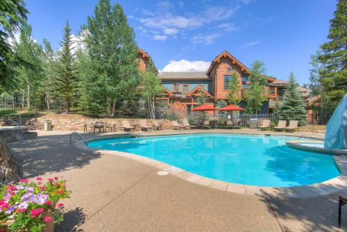 a swimming pool in front of a house at Mountain Thunder Lodge in Breckenridge