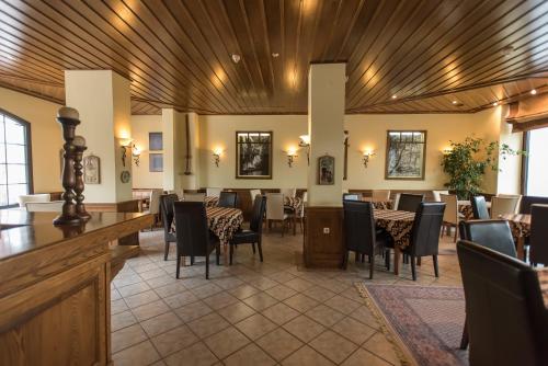 a restaurant with a dining room with tables and chairs at Anesis Hotel in Karpenision