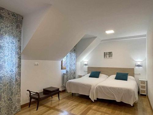 a bedroom with two beds with blue pillows at Casa Jabarde in Jaurrieta