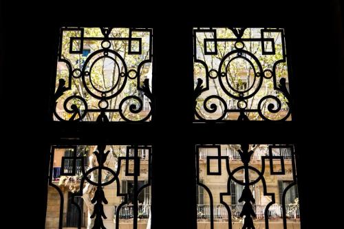 a window with four views of a building at Born Barcelona Hostel in Barcelona