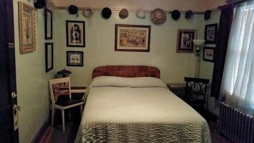 a bedroom with a bed and some pictures on the wall at A Sentimental Journey in Gettysburg