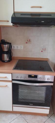 a kitchen with a stove top oven in a kitchen at Haseltal in Suhl