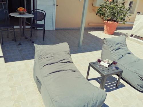 a couple of pillows sitting next to a table at Marinos Studios - 2nd floor studio in Póros Kefalonias