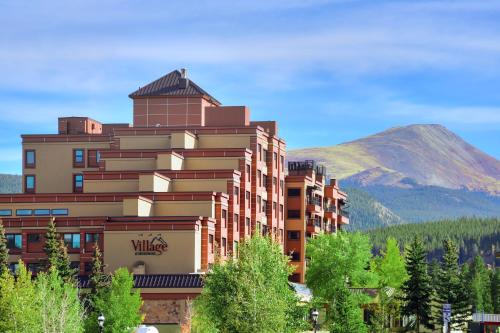 a hotel building with a mountain in the background at Village at Breckenridge, A Vail Resorts Property in Breckenridge