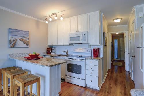 a kitchen with white cabinets and a counter top at Sea Cabin 131-B in Isle of Palms