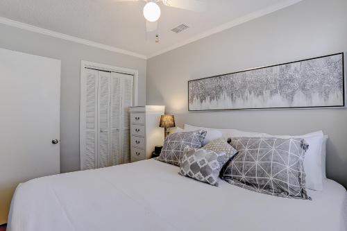 a bedroom with a white bed and two pillows at Sea Cabin 131 B in Isle of Palms