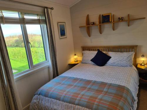 a bedroom with a bed and a large window at 3 Bedroom Lodge with Sea Views -Salcombe Retreat in Soar