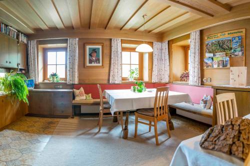 a kitchen and dining room with a table and chairs at Ruggenthalerhof in Matrei in Osttirol