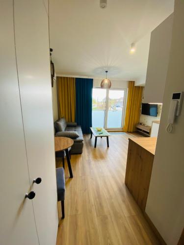 a living room with a couch and a table at Apartamenty Białe nad jeziorem Białym in Augustów