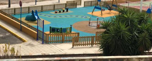 a small playground with a slide at Cala Apartamentos in Giniginámar