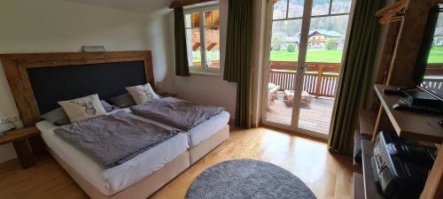 a bedroom with a bed and a balcony at Ferienhaus Pepi in Strobl