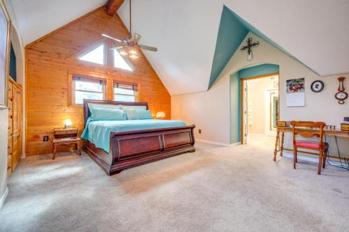 a bedroom with a bed and a desk in a room at Pet-Friendly Canyon Lake Cabin, 1 Mi to Water! in Canyon Lake