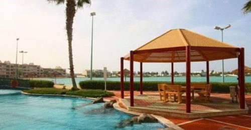 a pavilion in the middle of a swimming pool at Durrah Beach Apartment in Durat Alarous